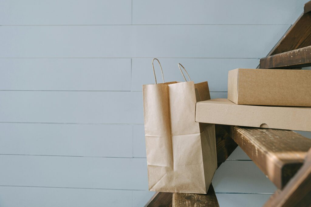 Minimalist image of paper and cardboard packaging on stairs, perfect for e-commerce themes.